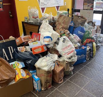 All the gathered cans and non perishable food for the canned food drive in the activities room. 