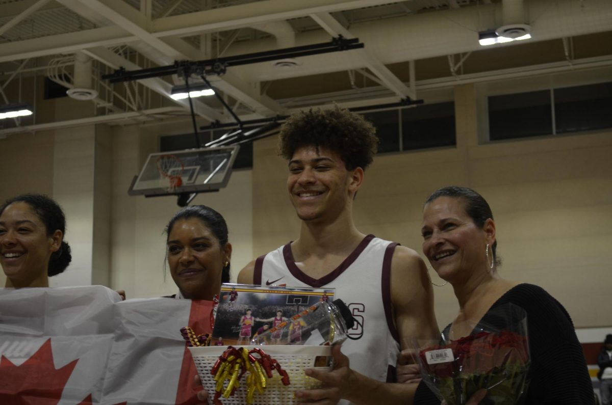 Airus Allen and family celebrating his seniority on the basketball team.